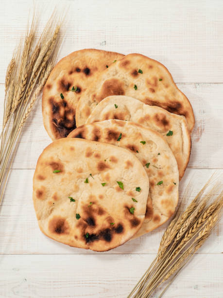 istock naan flatbreads on white wood, copy space, top view 1553262051