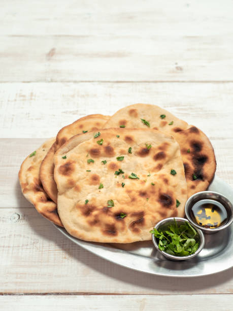 istock naan flatbreads on white wood, copy space, vertical 1553263135