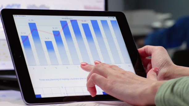 istock Close up of female hand scroll tablet screen with diagram 1553264223