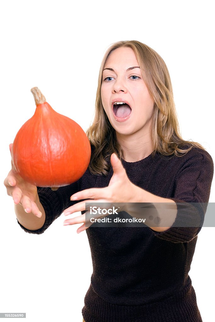 Beautiful girl with pumpkin Beautiful girl is trying to catch pumpkin Adult Stock Photo