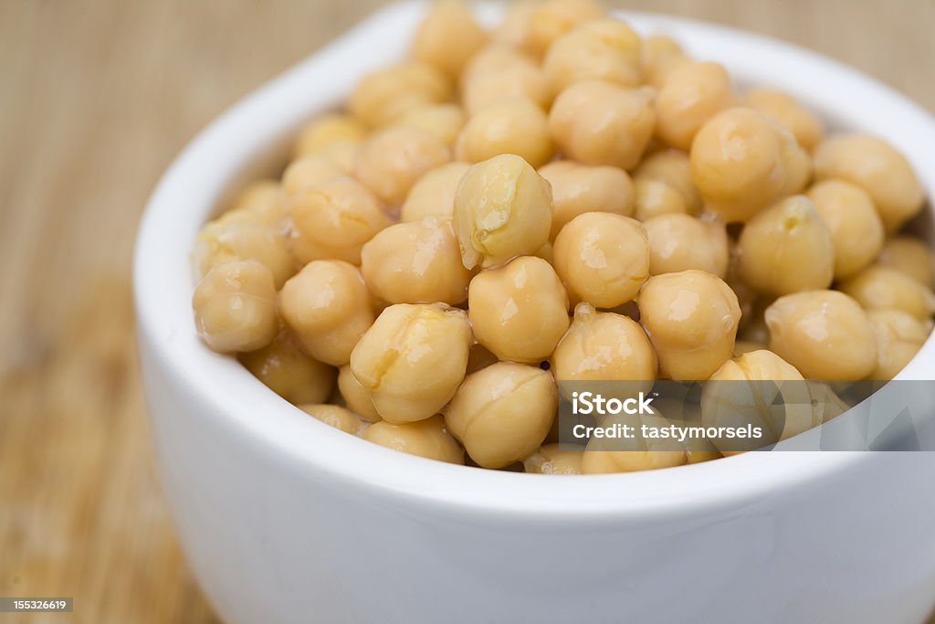 Chickpeas in a white bowl. Chickpeas chick-peas in a white bowl. Shallow depth of field. Chick-Pea Stock Photo