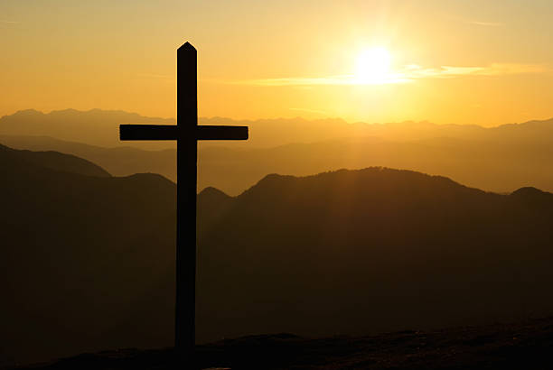 istock Christian cross at sunset 155327082