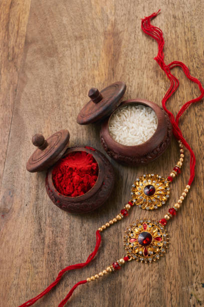 istock Raksha Bandhan background with Rakhi string, Rice Grains and Kumkum 1553271172