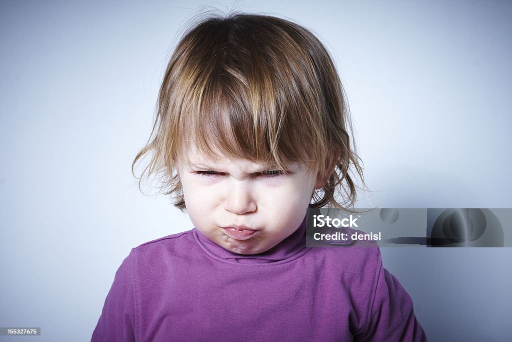 Angry child Child showing anger or disappointment, looking down Tantrum Stock Photo