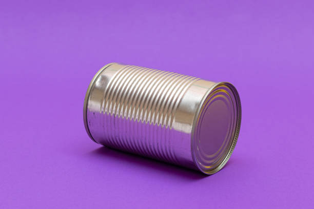 istock Unopened Tin Can with Blank Edge on Violet Background 1553276939