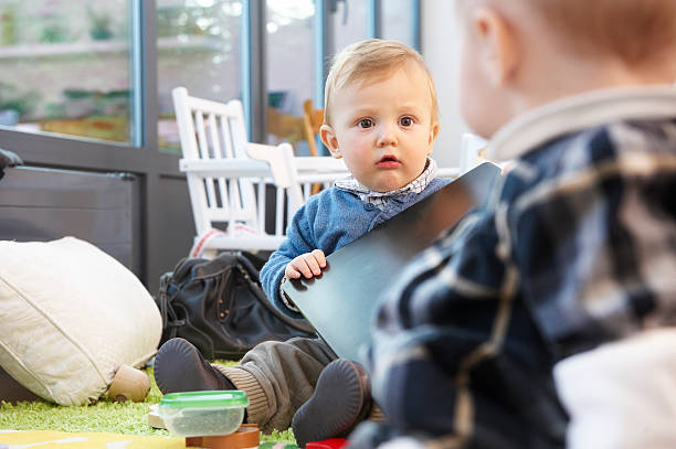 istock Two Babies on a Living Room Floor 155328344