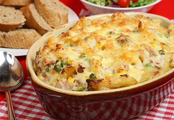 Tuna Pasta Bake Rigatoni pasta bake with tuna and topped with cheese. seafood gratin stock pictures, royalty-free photos & images