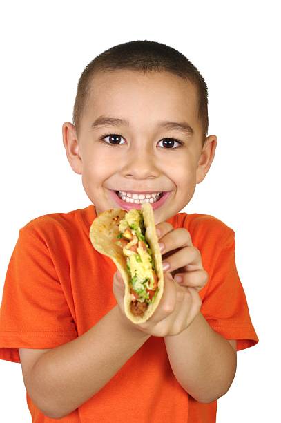 kid with a taco Six-year-old Hispanic boy holding a taco, isolated on white background   crew cut stock pictures, royalty-free photos & images