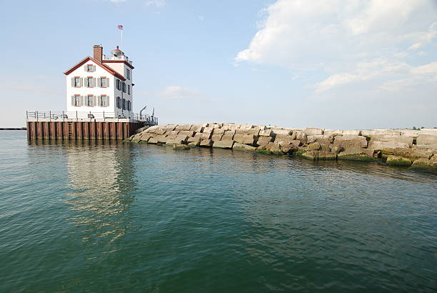 End Reflection Picture of the Lorain Lighthouse located in Lorain, Ohio on Lake Erie. Picture taken with a Nikon D80 from a boat.   lighthouse lighting equipment reflection rock stock pictures, royalty-free photos & images