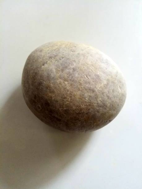 istock brown round pebbles on a white background 1553295759