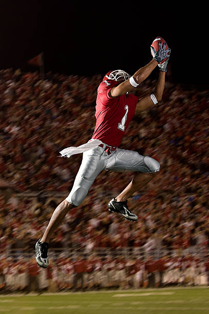 Football Catch Football catch intercept with crowd wide receiver athlete stock pictures, royalty-free photos & images