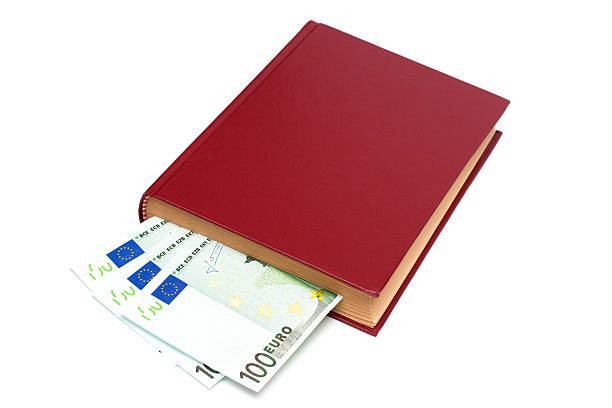 Money in book, isolated (Clipping path included) stock photo