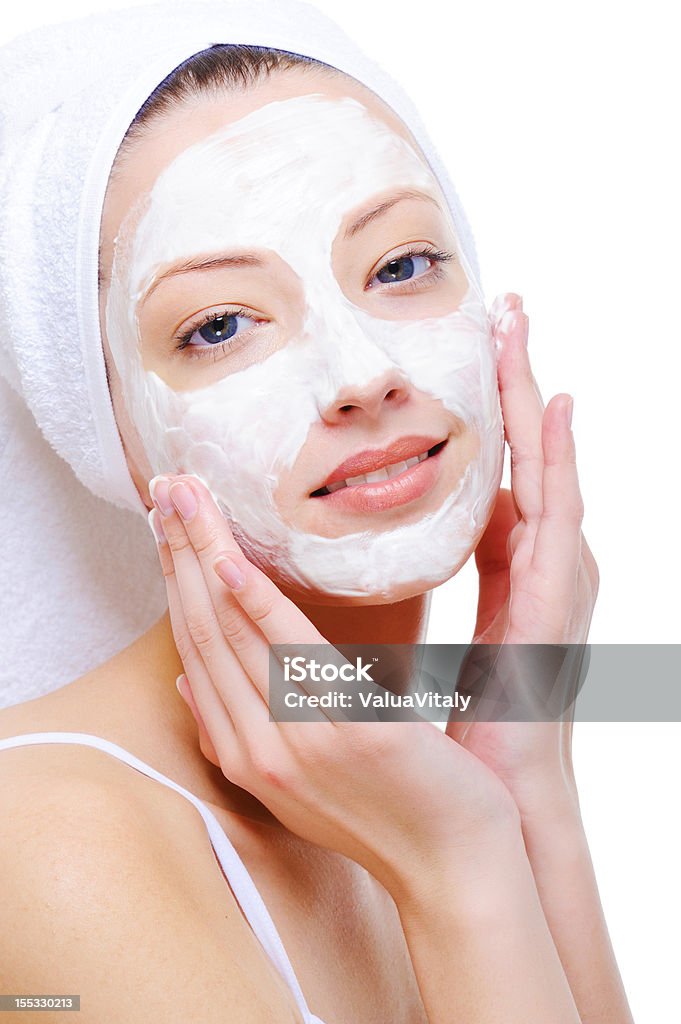 woman doing cosmetic mask beautiful young woman doing cosmetic mask on her face over white background 20-29 Years Stock Photo