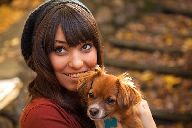 Young woman holding small dog stock photo