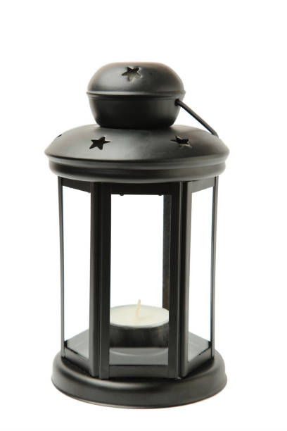 istock Vintage black lantern with candle isolated on white background. 1553307307
