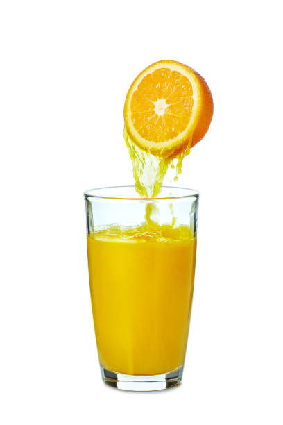 istock Juice pouring from orange fruit to glass on white 1553312141