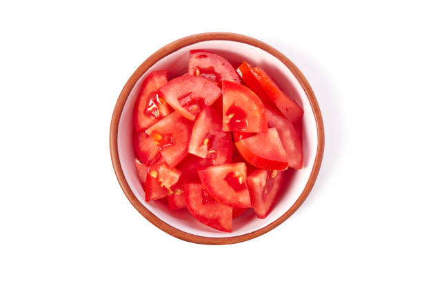 istock Bowl with chopped juicy tomatoes on white background 1553312738