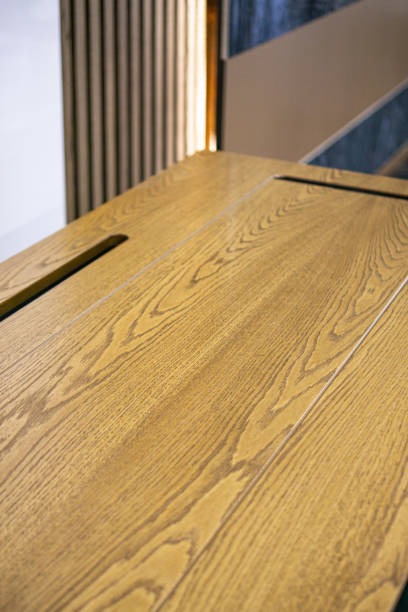 istock Empty rough wooden table top in the dark room 1553314957