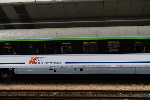 Krakow, Poland - May 6, 2023: PKP Intercity passenger train at Kraków Główny Main Railway Station platform. Polish state railways long-distance express.