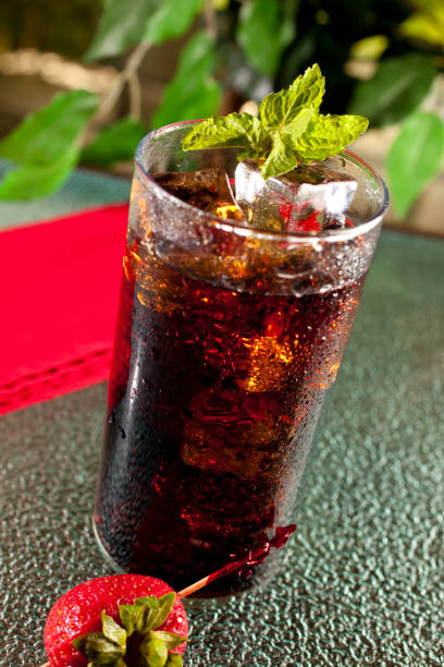 istock Ice cold drink with mint and strawberry on table napkin 155335526