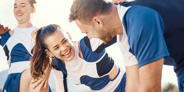 istock Cheerleader, funny or people in cheerleading team talking, bonding or laughing while relaxing on field. Community, sports friends or group of happy cheerleaders with support or solidarity together 1553366861