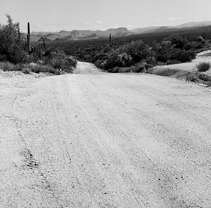 Black and White Film image of the Sonora desert dirt Road in central Arizona USA