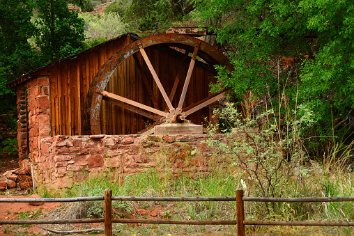 An Old rural Water Wheel on a stone foundation