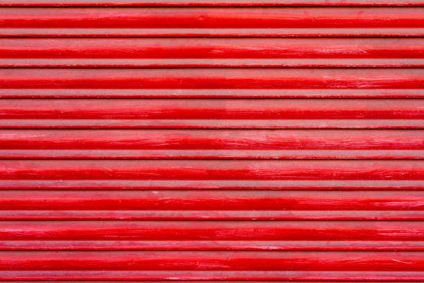 istock Textured background of red wooden roller shutter door close up 1553382578