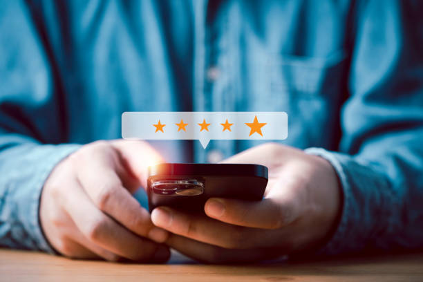 istock Businessman using smartphone to give golden five stars for client the best satisfaction evaluation survey after use product and service concept. 1553382598