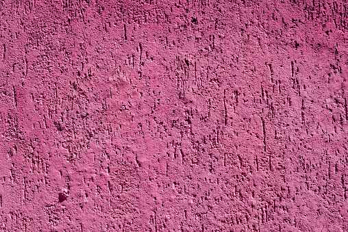 Abstract background with pink colored decorative plaster.