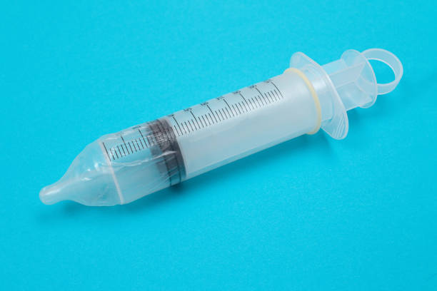 istock Anti Vaccination Concept - Syringe in a Condom 1553385393