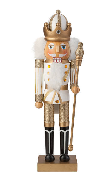 Christmas Nutcracker with clipping path Christmas Nutcracker  with a white uniform and gold pants. The figure rain appears to be a king with a crown and a miter. The image is isolated on a white background, and includes a clipping path.  The nutcracker is a device for cracking nuts but is often used as a decoration at Christmas time. nutcracker photos stock pictures, royalty-free photos & images