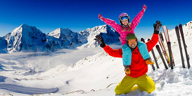 Ski family child carrying on shoulders stock photo