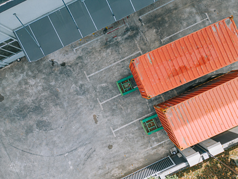 Drone point of view directly below Factory warehouse logistic building Industrial District in the morning