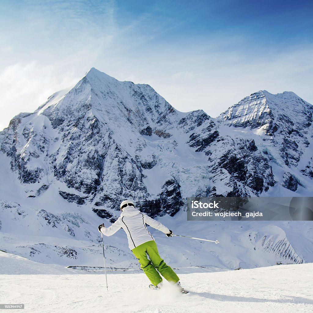 Ski Skiing - woman skiing in italian Alps Activity Stock Photo