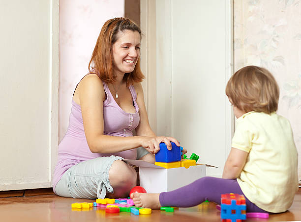 istock Happy mother plays with baby 155344157