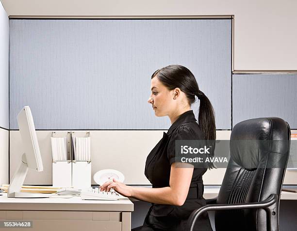 Businesswoman Typing On Computer At Desk Stock Photo - Download Image Now - Office Cubicle, One Woman Only, Posture