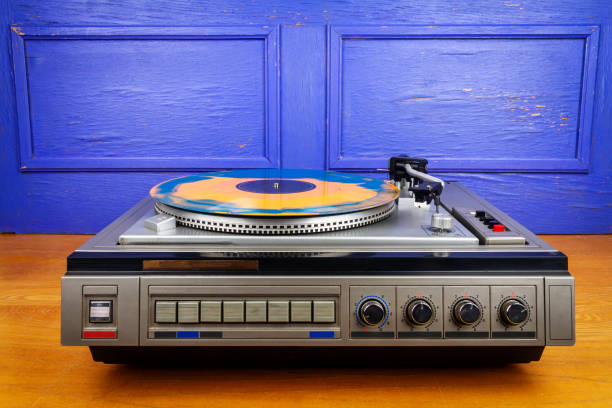 istock Vintage turntable vinyl record player with blue and orange vinyl 1553452385