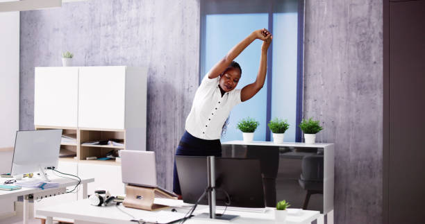 istock Arms Stretch Exercise Standing Near Desk 1553459956