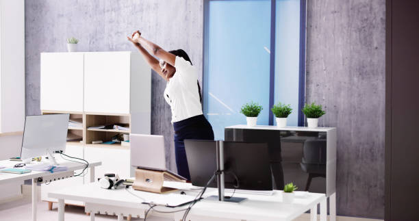 istock Arms Stretch Exercise Standing Near Desk 1553459958