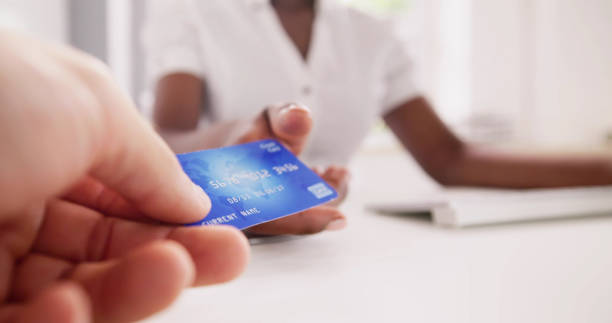 istock Cashier Hand Holding Debit Or Credit Card 1553459990