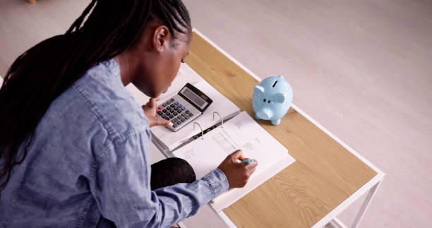 Young African Woman Calculating Invoice stock photo