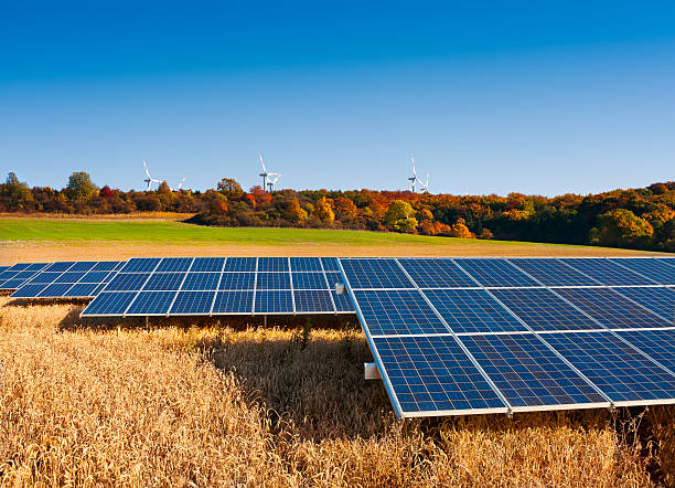 Solar panels and windmills in Autumn stock photo