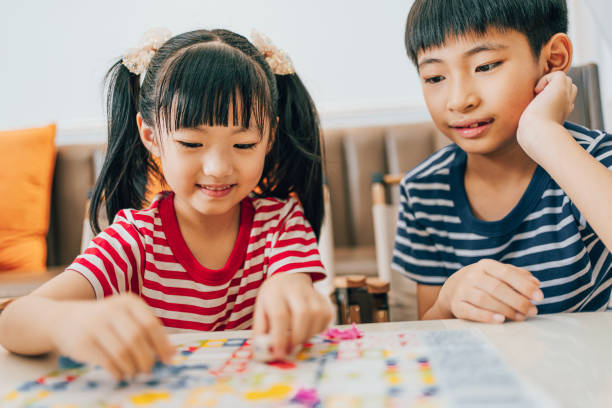 istock Brother and sister play chess 1553484897