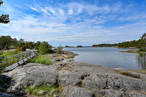 wooden foot bridge over water from to iland Stendorren nature reserv Nykoping Sweden july 15 2023