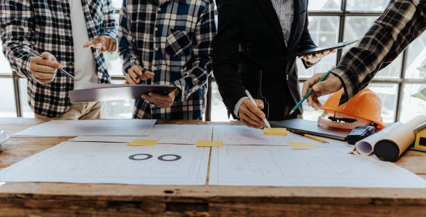 istock Civil engineer team meeting Modern construction planning meeting, foreman, industrial project manager, engineering team, professional team in Asian industry 1553499144