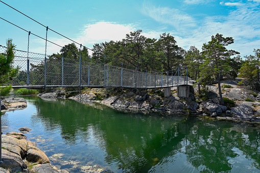 suspension bridge to island in Stendorren nature reserve Nykoping Sweden july 15 2023