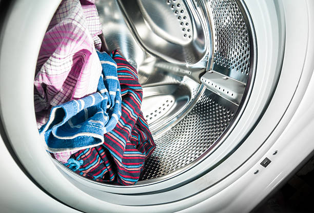 Laundry inside a washing machine drum stock photo