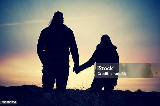 Photo libre de droit de Couple Tenant Les Mains Silhouette Au Coucher Du Soleil banque d'images et plus d'images libres de droit de Adulte