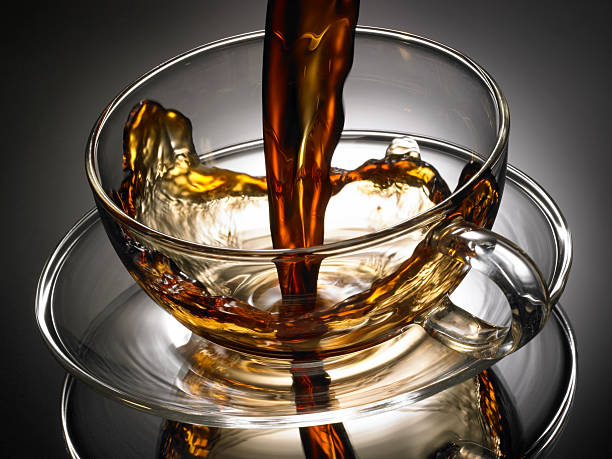 Coffe pouring into glass cup with splash